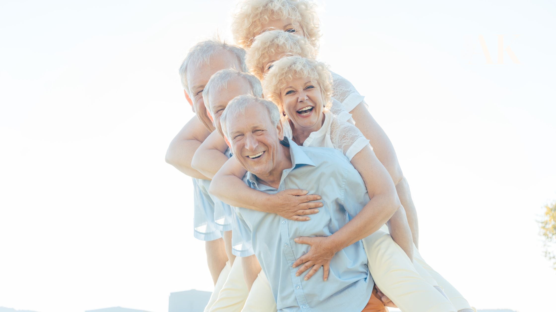 Smiling older adults enjoying the outdoors together, symbolizing healthy aging, skin wellness, and active lifestyle support for people living with actinic keratosis.