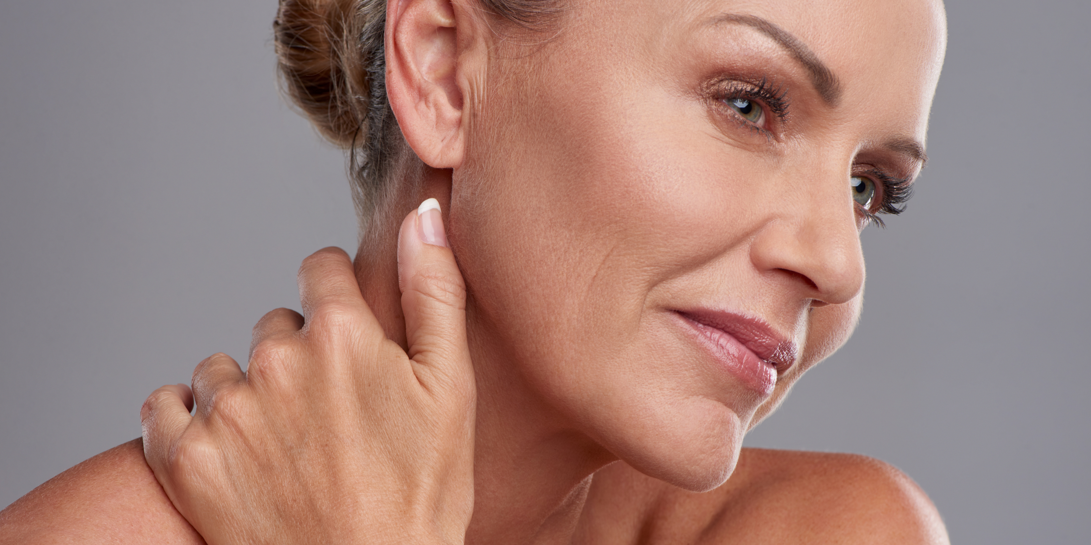 Person looking closely at a rough, flaky patch of sun-damaged skin on the face, illustrating actinic keratosis and the importance of avoiding picking to support healthy skin care and monitoring.
