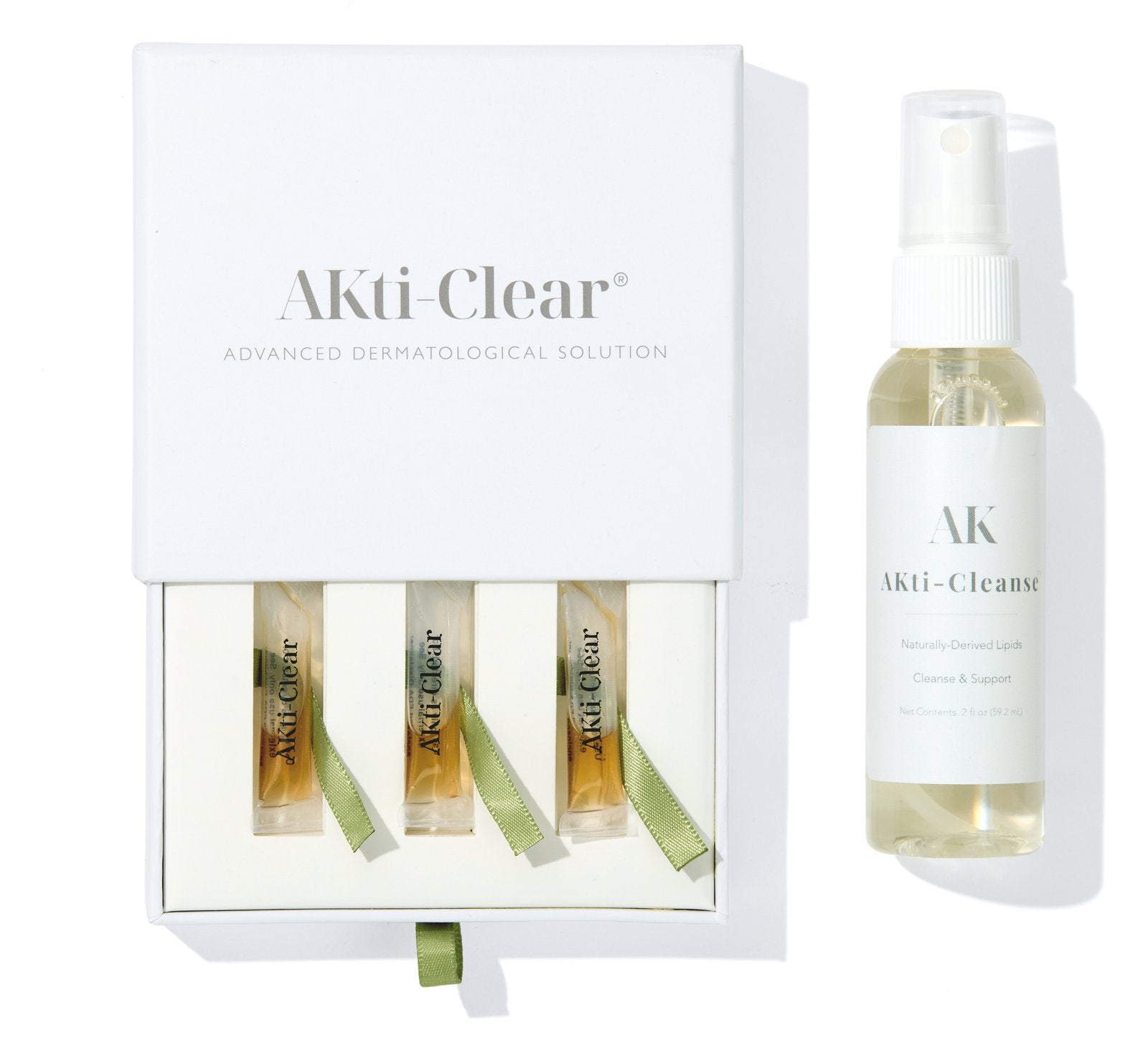 AKti-Clear kit: three ampoules in the open box beside the AKti-Cleanse spray bottle